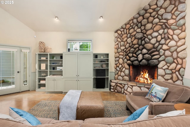 8917 Spindrift Ln, Manzanita, OR 97130 - living room featuring vaulted ceiling, a stone fireplace, and light tile patterned flooring