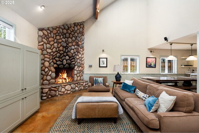8917 Spindrift Ln, Manzanita, OR 97130 - living area featuring high vaulted ceiling, finished concrete floors, and a stone fireplace