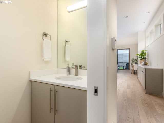 3770 NE 7th Ave, Portland, OR 97212 - bathroom featuring wood finished floors, vanity, and recessed lighting