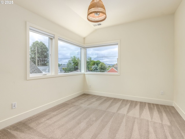 3770 NE 7th Ave, Portland, OR 97212 - empty room with plenty of natural light, light colored carpet, baseboards, and vaulted ceiling