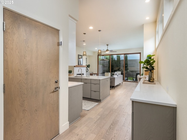 3770 NE 7th Ave, Portland, OR 97212 - kitchen featuring gray cabinets, a sink, light countertops, a peninsula, and recessed lighting