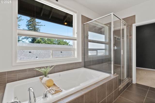 full bathroom featuring plenty of natural light, a stall shower, tile patterned flooring, and a bath