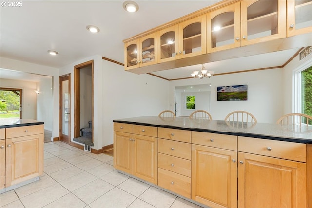 3400 SW 110th Ave, Beaverton, OR 97005 - kitchen with light tile patterned floors, light brown cabinetry, glass insert cabinets, and a notable chandelier