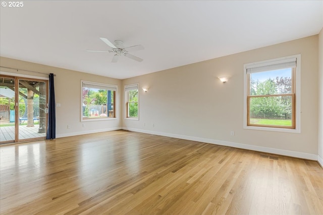 3400 SW 110th Ave, Beaverton, OR 97005 - empty room featuring baseboards, plenty of natural light, ceiling fan, and light wood finished floors