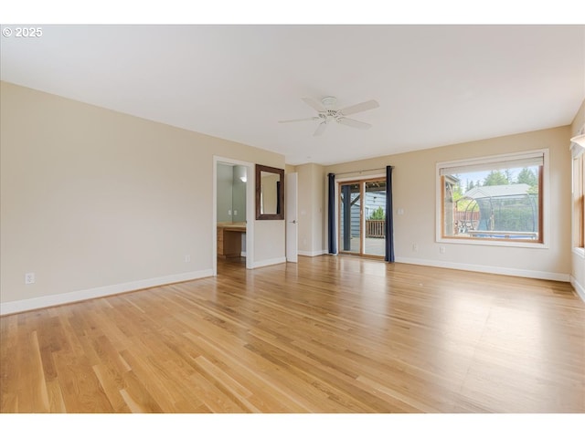 unfurnished room featuring baseboards, ceiling fan, and light wood-type flooring