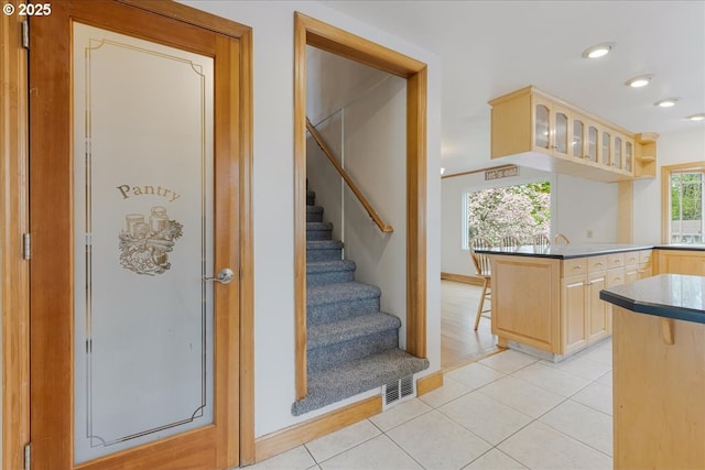 3400 SW 110th Ave, Beaverton, OR 97005 - kitchen featuring light brown cabinetry, a kitchen breakfast bar, visible vents, and light tile patterned floors