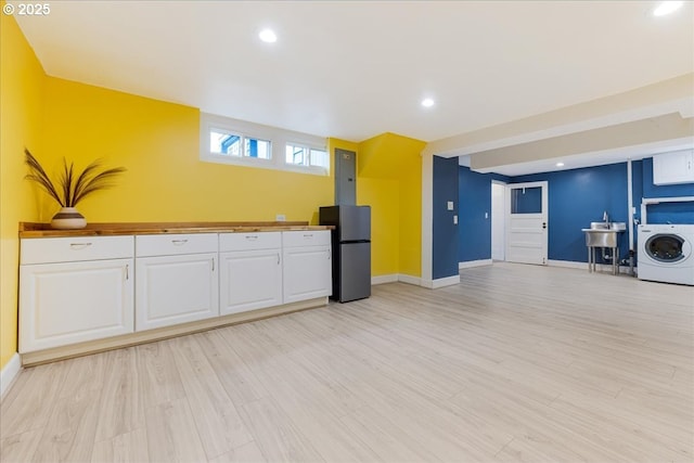 3400 SW 110th Ave, Beaverton, OR 97005 - kitchen featuring baseboards, freestanding refrigerator, washer / clothes dryer, and white cabinetry