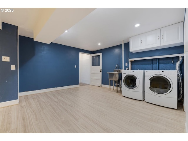 laundry area featuring cabinet space, recessed lighting, baseboards, light wood-type flooring, and washer and clothes dryer