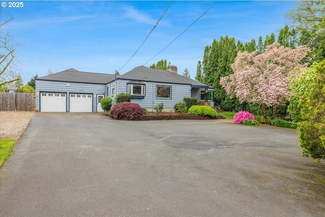 3400 SW 110th Ave, Beaverton, OR 97005 - ranch-style house featuring an attached garage, fence, driveway, and a chimney