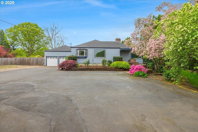 3400 SW 110th Ave, Beaverton, OR 97005 - single story home with a garage, aphalt driveway, fence, and a chimney