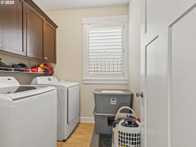 924 Park St, Sweet Home, OR 97386 - clothes washing area featuring separate washer and dryer, baseboards, cabinet space, and light wood-style flooring