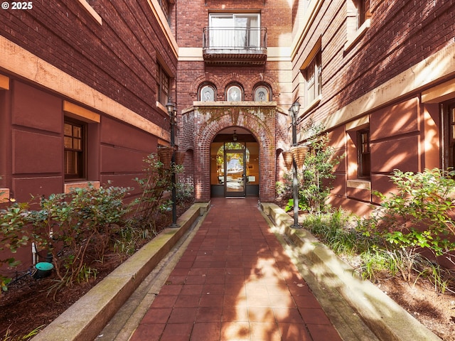 doorway to property featuring french doors and brick siding