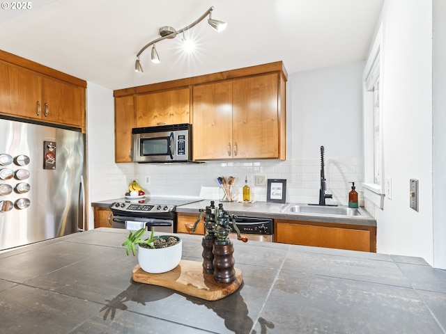 kitchen with sink, backsplash, tile countertops, and stainless steel appliances