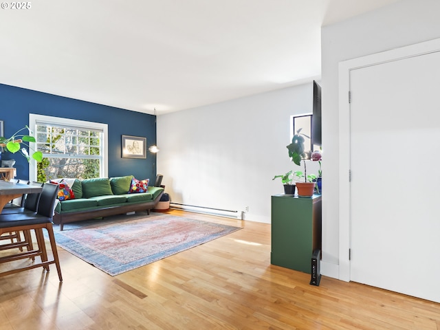 living room featuring light wood-type flooring and a baseboard radiator