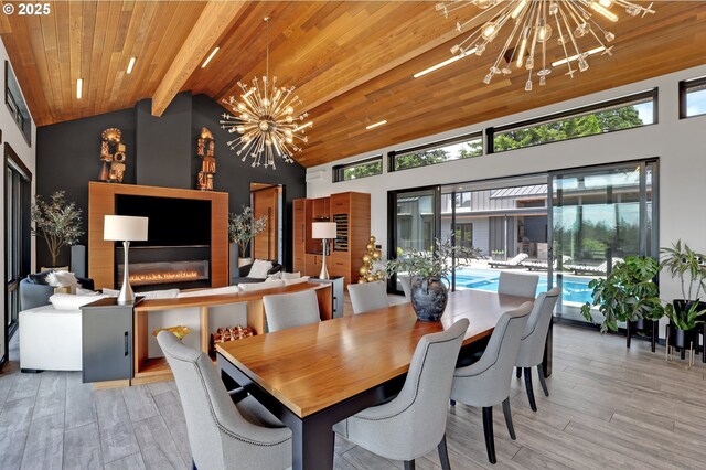 11440 NW Rock Creek Rd, Portland, OR 97231 - dining room featuring a chandelier, light wood-style floors, wooden ceiling with exposed beams, a large fireplace, and high vaulted ceiling