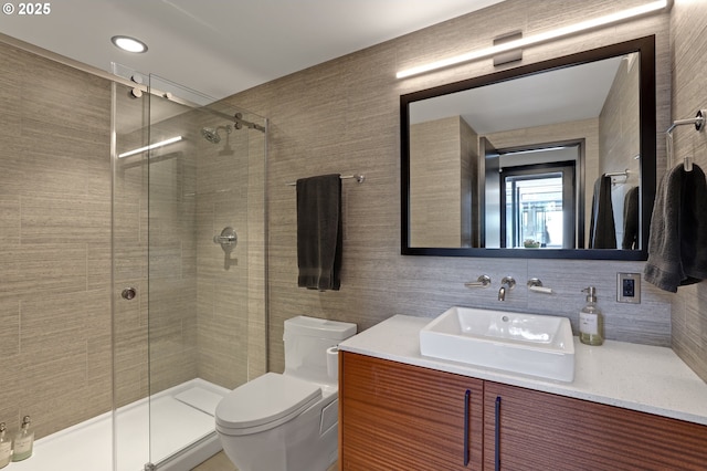 11440 NW Rock Creek Rd, Portland, OR 97231 - full bathroom with a stall shower, toilet, vanity, decorative backsplash, and tile walls