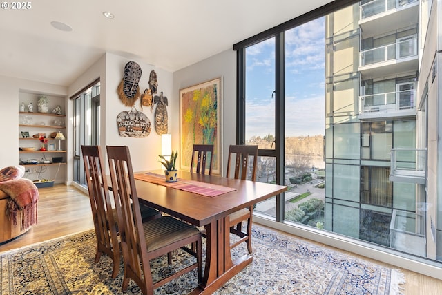 dining area featuring built in features and hardwood / wood-style flooring