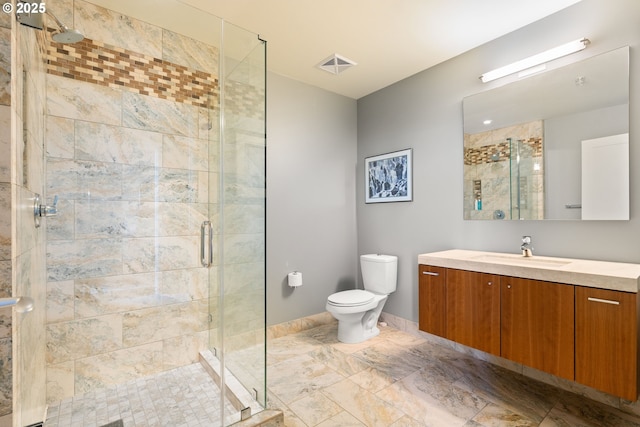 bathroom with vanity, an enclosed shower, and toilet