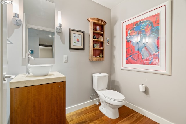 bathroom featuring hardwood / wood-style flooring, vanity, and toilet