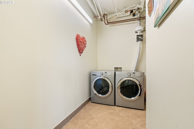 clothes washing area with washer and clothes dryer