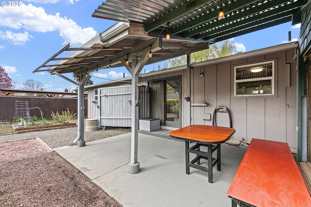view of patio / terrace featuring fence and a pergola