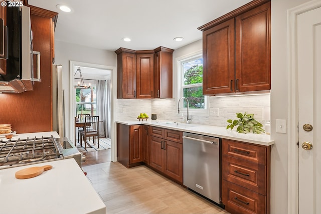 4595 NE 34th Ave, Portland, OR 97211 - kitchen featuring dishwasher, healthy amount of natural light, light countertops, decorative backsplash, and recessed lighting
