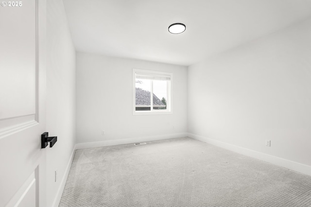 empty room with light colored carpet