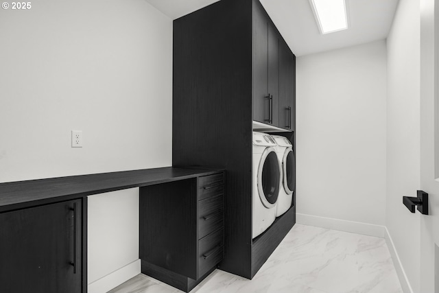 laundry room featuring cabinets and washer and clothes dryer