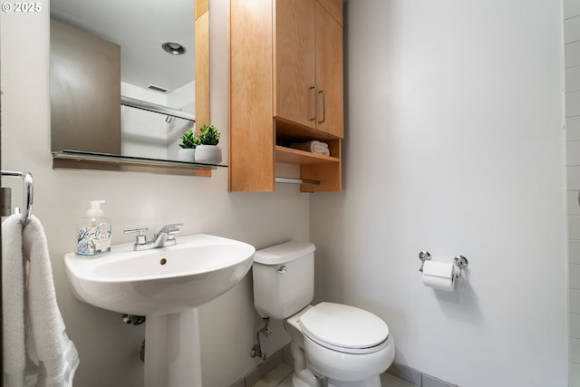 bathroom featuring an enclosed shower and toilet