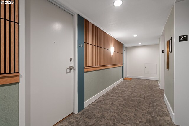 hallway featuring ornamental molding and carpet floors