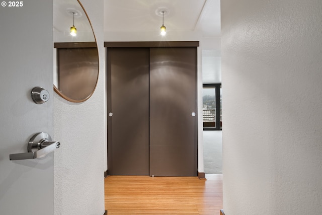 hallway with light wood-type flooring