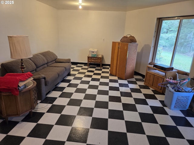 living area with tile patterned floors and baseboards