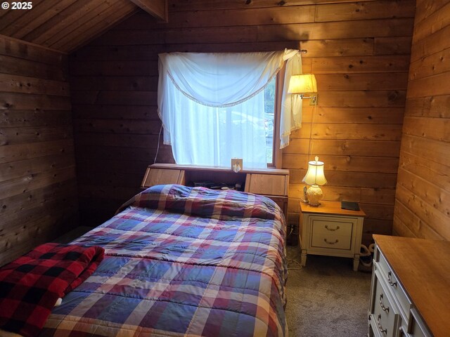 bedroom featuring vaulted ceiling, wooden walls, carpet flooring, and wood ceiling