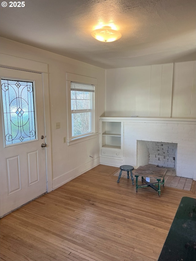 foyer featuring a textured ceiling and light hardwood / wood-style floors