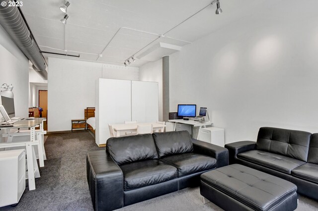 1400 NW Irving St Unit 618, Portland, OR 97209 - living area with track lighting and dark carpet