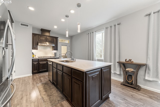 9414 NE 166th Ave, Vancouver, WA 98682 - kitchen with appliances with stainless steel finishes, a sink, dark brown cabinetry, under cabinet range hood, and recessed lighting
