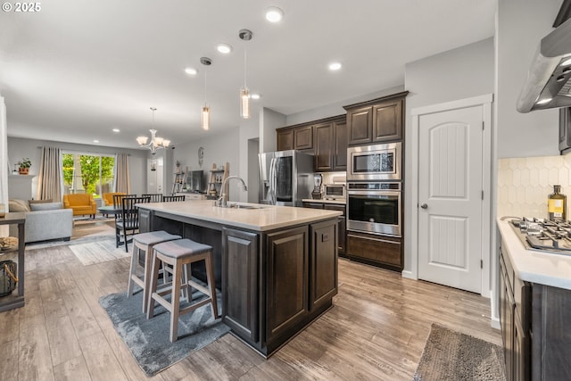 9414 NE 166th Ave, Vancouver, WA 98682 - kitchen with appliances with stainless steel finishes, dark brown cabinets, a sink, light countertops, and a chandelier