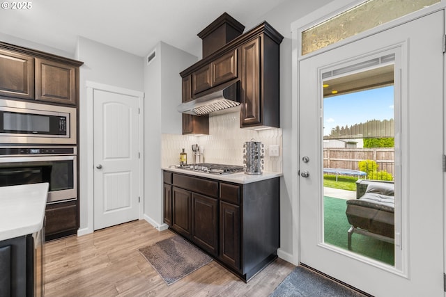 9414 NE 166th Ave, Vancouver, WA 98682 - kitchen with stainless steel appliances, under cabinet range hood, light countertops, and dark brown cabinetry