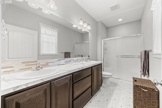 9414 NE 166th Ave, Vancouver, WA 98682 - full bathroom with tile patterned floors, double vanity, a shower stall, toilet, and decorative backsplash