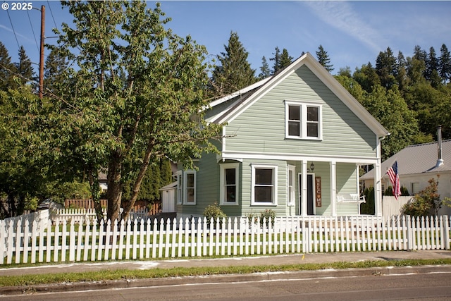 view of front of house featuring covered porch and a fenced front yard