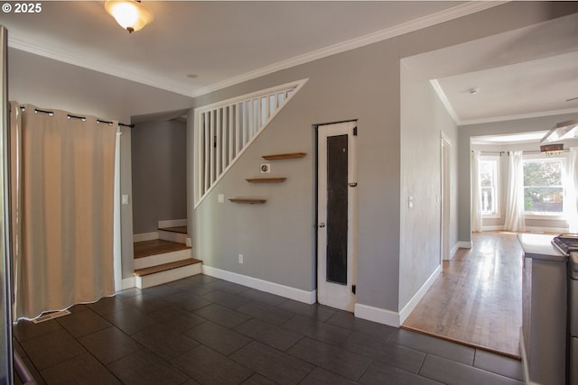 foyer entrance with stairs, baseboards, crown molding, and dark tile patterned flooring