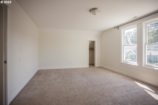 unfurnished bedroom with light carpet and baseboards