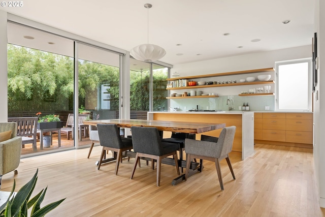 435 N Shaver St, Portland, OR 97227 - dining room with wet bar, a wall of windows, and light wood-style floors