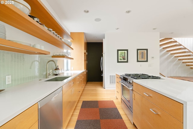 435 N Shaver St, Portland, OR 97227 - kitchen with open shelves, a sink, stainless steel appliances, light wood-type flooring, and modern cabinets