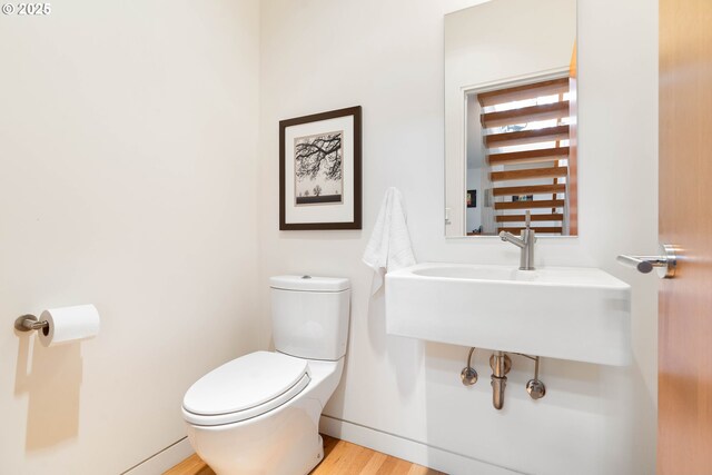 435 N Shaver St, Portland, OR 97227 - bathroom with toilet, wood finished floors, and baseboards