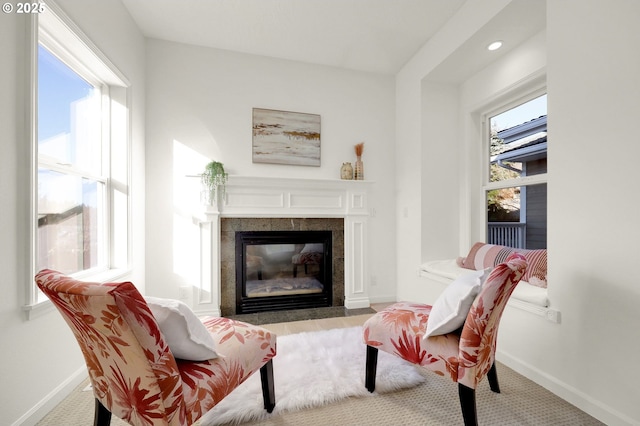 sitting room with a fireplace, baseboards, a wealth of natural light, and recessed lighting