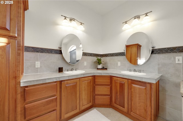 full bathroom featuring a sink, tile walls, and double vanity