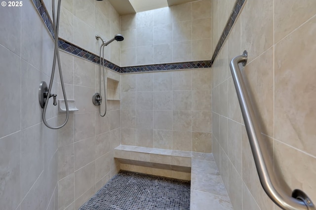 bathroom with a tile shower