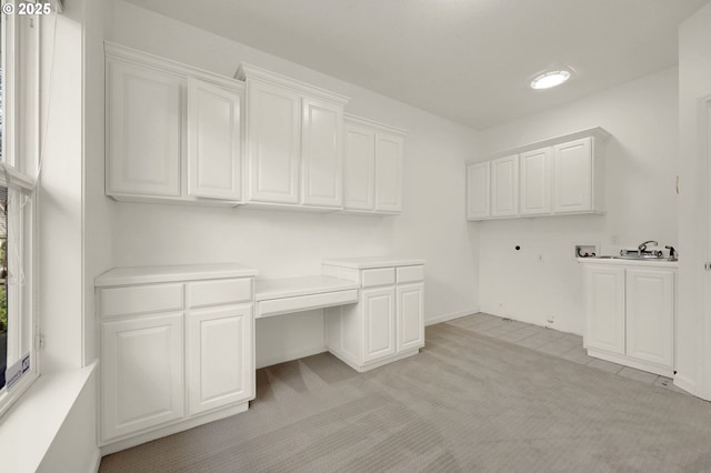 laundry room with cabinet space, washer hookup, and light colored carpet