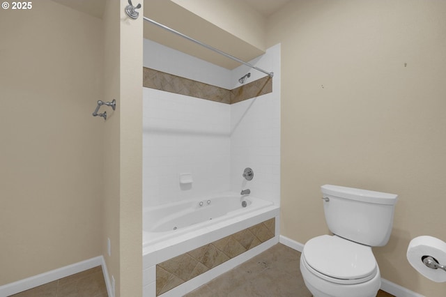 bathroom featuring baseboards, tiled shower / bath combo, toilet, and tile patterned floors